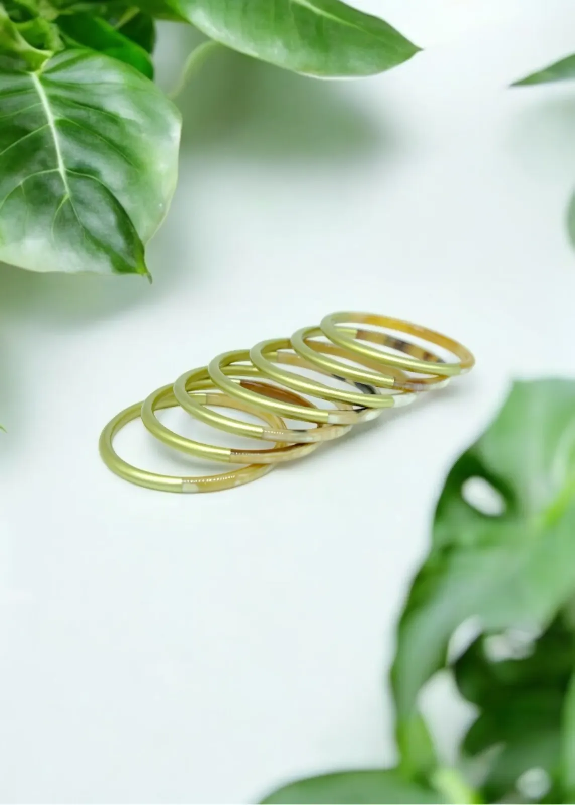 Stack of natural horn bangles with gold lacquer