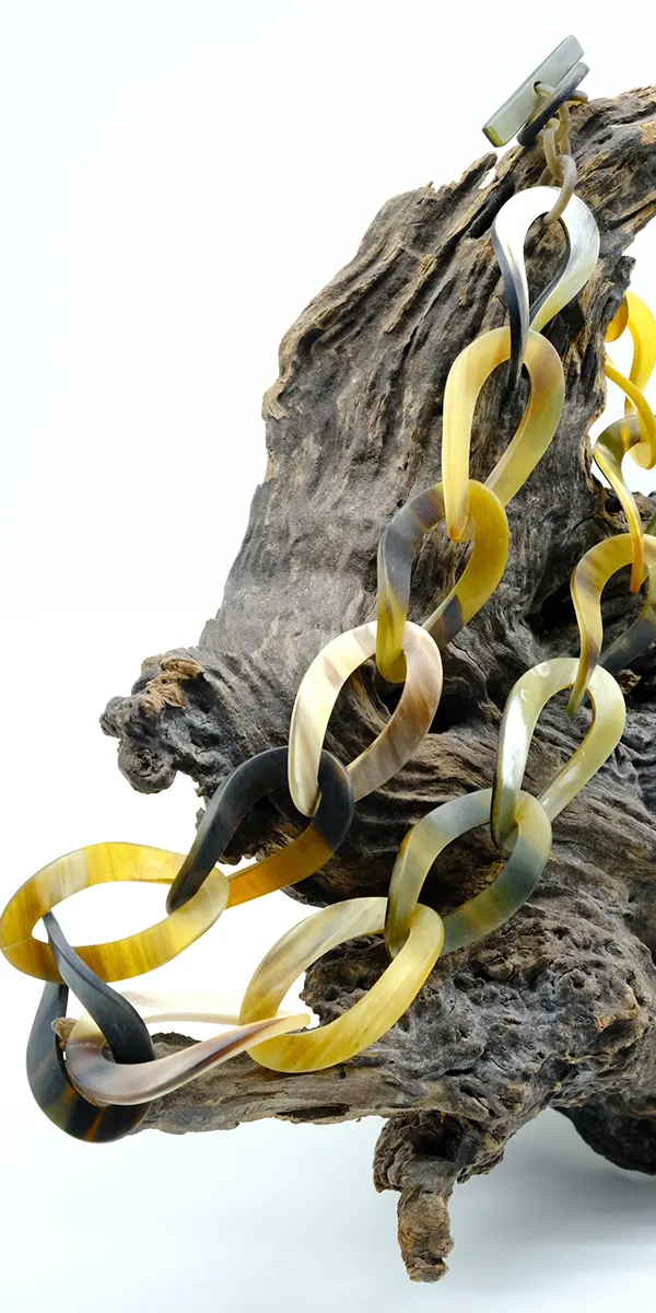Natural buffalo horn link necklace on driftwood