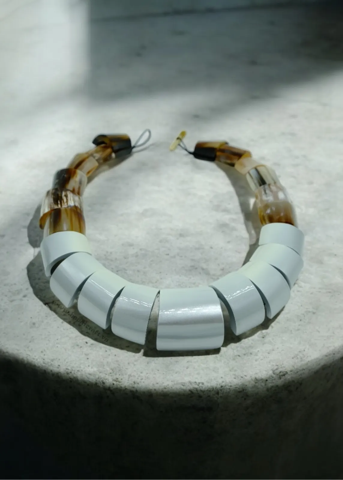 White lacquer and horn statement necklace on stone